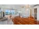 Bright living room with wood floors, water view, spiral staircase, and comfortable seating at 6423 Driftwood Dr, Hudson, FL 34667