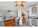 Open-concept living area with hardwood floors, spiral staircase, kitchen, and comfortable seating at 6423 Driftwood Dr, Hudson, FL 34667