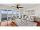 A bright living room with hardwood floors, scenic views, and comfortable seating arrangements at 6423 Driftwood Dr, Hudson, FL 34667