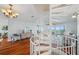 Open concept living room with spiral staircase, hardwood floors, and waterfront views at 6423 Driftwood Dr, Hudson, FL 34667