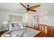 Comfortable living room with hardwood floors, a spiral staircase, and a large ceiling fan at 6423 Driftwood Dr, Hudson, FL 34667