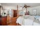 Spacious bedroom boasts hardwood floors, accent art, and access to en-suite bathroom with a soaking tub at 6423 Driftwood Dr, Hudson, FL 34667