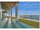 Waterfront patio with columns and views of the pier and bay at 6423 Driftwood Dr, Hudson, FL 34667
