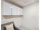 Practical storage area with white cabinets and tiled flooring at 6423 Driftwood Dr, Hudson, FL 34667