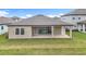 The backyard has a covered patio, providing a comfortable space to enjoy the outdoors and the well-maintained lawn at 13028 Homestead Ln, Parrish, FL 34219