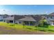 Home backyard has a covered patio, providing an inviting outdoor space with lush green grass and young trees at 13028 Homestead Ln, Parrish, FL 34219