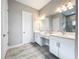Spacious bathroom with double vanity, tile floors, and modern fixtures and bright lighting at 13028 Homestead Ln, Parrish, FL 34219