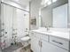 Well-lit bathroom with a shower-tub combination and modern white vanity at 13028 Homestead Ln, Parrish, FL 34219