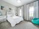 Bright bedroom with beach themed decor, large windows, and cozy carpet flooring at 13028 Homestead Ln, Parrish, FL 34219