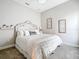 Bright bedroom featuring a large bed, neutral decor, and comfortable carpet flooring at 13028 Homestead Ln, Parrish, FL 34219