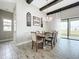 Dining room with chandelier lighting, wood accents, and adjacent access to a patio at 13028 Homestead Ln, Parrish, FL 34219
