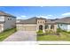 Beautiful single-story home showcasing neutral stucco, brick driveway, manicured landscaping, and a three-car garage at 13028 Homestead Ln, Parrish, FL 34219