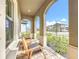 Inviting front porch with brick flooring and comfortable rocking chairs overlooking manicured landscaping at 13028 Homestead Ln, Parrish, FL 34219