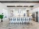 Open kitchen with large island and breakfast bar, stainless steel appliances, and pendant lighting at 13028 Homestead Ln, Parrish, FL 34219