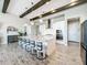 Spacious kitchen featuring a large island with seating, modern appliances, and pendant lighting at 13028 Homestead Ln, Parrish, FL 34219