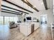 Bright kitchen with white cabinetry, a large island, pendant lighting, and views of the living room and backyard at 13028 Homestead Ln, Parrish, FL 34219
