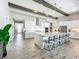 Spacious kitchen with an island, white cabinets, stainless steel appliances, pendant lighting and seating for five at 13028 Homestead Ln, Parrish, FL 34219