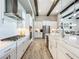 Beautiful kitchen featuring white cabinetry, stainless steel appliances, a large island, and open living space at 13028 Homestead Ln, Parrish, FL 34219