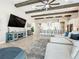 Open-concept living area features wood beams, an entertainment center, and seamless flow to the kitchen at 13028 Homestead Ln, Parrish, FL 34219
