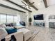 Bright living room boasts wood beams, ceiling fan, and large windows for plenty of natural light at 13028 Homestead Ln, Parrish, FL 34219