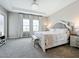 The main bedroom features a tray ceiling, a chandelier, and neutral decor at 13028 Homestead Ln, Parrish, FL 34219