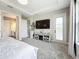 The main bedroom has a large television and a view of the main bathroom at 13028 Homestead Ln, Parrish, FL 34219