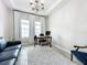 The home office has a tray ceiling, modern chair and is naturally lit at 13028 Homestead Ln, Parrish, FL 34219