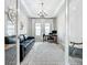 This home office features a classic wood desk, elegant chandelier, and plenty of light at 13028 Homestead Ln, Parrish, FL 34219