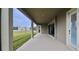 Covered patio features sleek columns, recessed lighting, and access to the backyard, perfect for outdoor relaxation and entertaining at 13028 Homestead Ln, Parrish, FL 34219