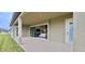 Covered patio with sliding glass doors provides an outdoor living space, seamlessly connecting indoor and outdoor living at 13028 Homestead Ln, Parrish, FL 34219