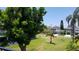 Lush green backyard with manicured lawn and views of nearby houses at 255 Capri N Cir # 17, Treasure Island, FL 33706