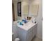 Bathroom featuring a white vanity with sink, mirror, and stylish storage shutters at 255 Capri N Cir # 17, Treasure Island, FL 33706