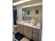 Neutral bathroom features double sinks, spacious countertops, and a large mirror at 255 Capri N Cir # 17, Treasure Island, FL 33706
