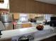 Bright kitchen featuring stainless steel appliances and breakfast bar with white countertops at 255 Capri N Cir # 17, Treasure Island, FL 33706