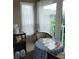 Sunroom provides a relaxing space with a table, natural light, and a view of the outdoors at 255 Capri N Cir # 17, Treasure Island, FL 33706