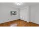 Bright bedroom features parquet floors and a large window with a view to the outside at 4902 Stolls Ave, Tampa, FL 33615
