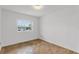 Bright bedroom features parquet floors and a large window with a view to the outside at 4902 Stolls Ave, Tampa, FL 33615