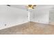 Bedroom includes a ceiling fan, hardwood floors, and a neutral color palette at 4902 Stolls Ave, Tampa, FL 33615