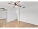 Bright bedroom features parquet floors, and a closet with a sliding mirrored door at 4902 Stolls Ave, Tampa, FL 33615