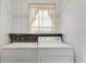 Laundry room featuring washer and dryer hookups and a curtained window at 4902 Stolls Ave, Tampa, FL 33615