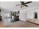Spacious living room includes a ceiling fan, tile floor, and a door leading to a sunroom at 4902 Stolls Ave, Tampa, FL 33615
