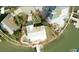 Aerial view of waterfront property featuring lush landscaping, private pool, and boat dock at 7800 3Rd S Ave, St Petersburg, FL 33707