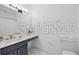 Well-lit bathroom with a granite countertop, stylish vanity, and ample space at 8856 Christie Dr # 0, Largo, FL 33771