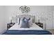 Stylishly decorated bedroom featuring bedside tables, lamps, and decorative wall art at 8856 Christie Dr # 0, Largo, FL 33771