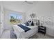 Well-lit bedroom featuring a large window, neutral colors, and comfortable furnishings at 8856 Christie Dr # 0, Largo, FL 33771
