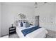 Relaxing bedroom featuring a plush bed with stylish gray bedding and decorative wall art at 8856 Christie Dr # 0, Largo, FL 33771