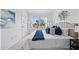 Cozy bedroom with a large window, neutral decor, and a comfortable bed at 8856 Christie Dr # 0, Largo, FL 33771