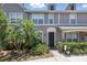Beautiful townhome exterior with lush tropical landscaping, well-manicured walkway, and inviting front entrance at 8856 Christie Dr # 0, Largo, FL 33771