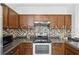 Updated kitchen with wooden cabinetry, stainless steel appliances, and a granite countertop at 8856 Christie Dr # 0, Largo, FL 33771