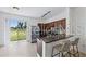 Open kitchen with a breakfast bar, stainless appliances, dark wood cabinets and abundant sunlight at 8856 Christie Dr # 0, Largo, FL 33771
